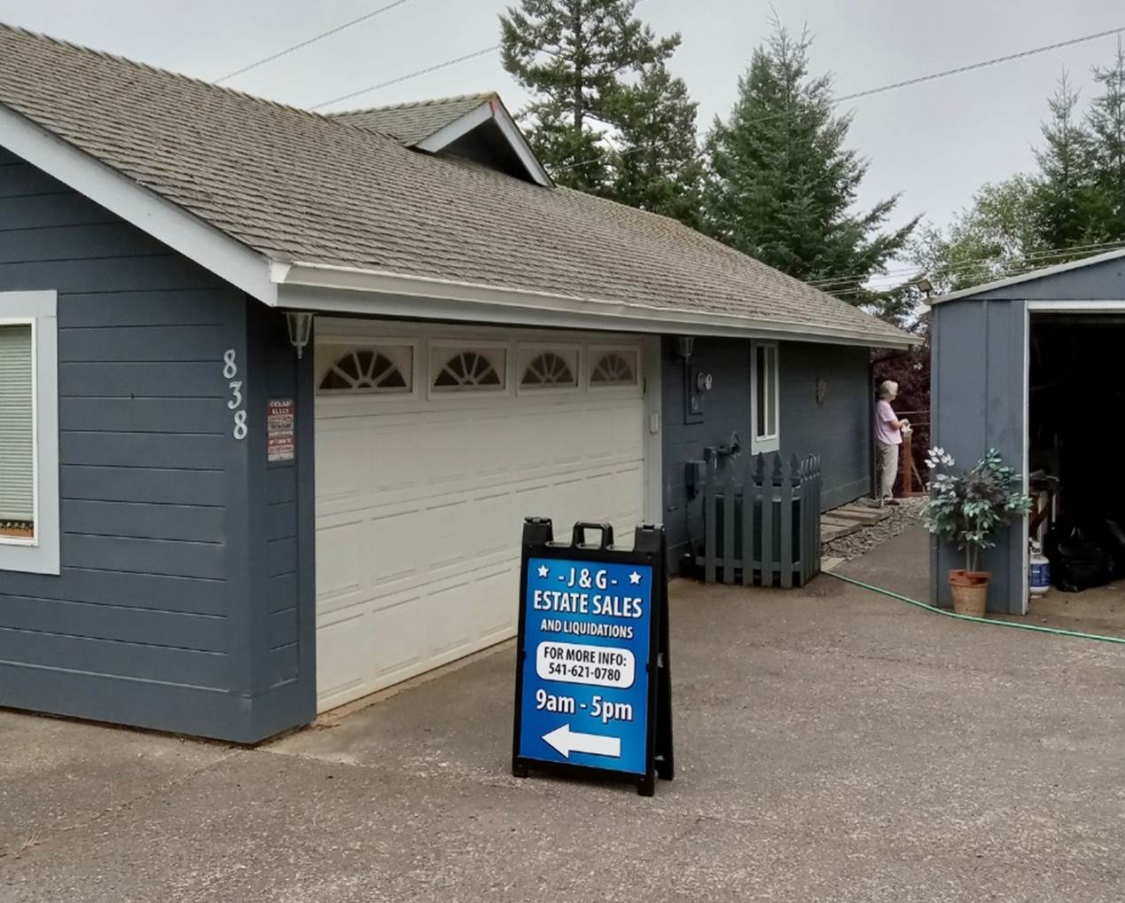 A house with a estate sales sign in front of it

Description automatically generated
